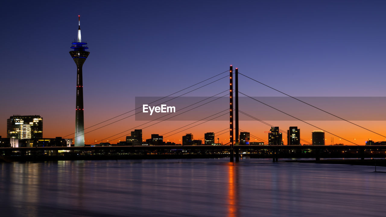 Colorful sunset on the rhine river with the cityscape of dusseldorf in the background, germany