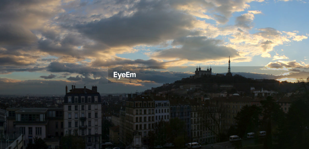 High angle view of buildings in city at sunset