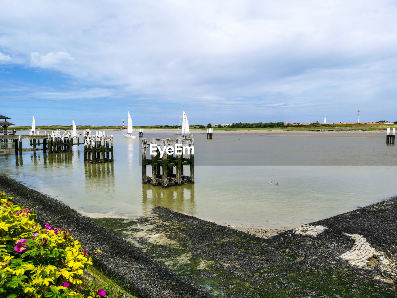 Scenic view of lake against cloudy sky