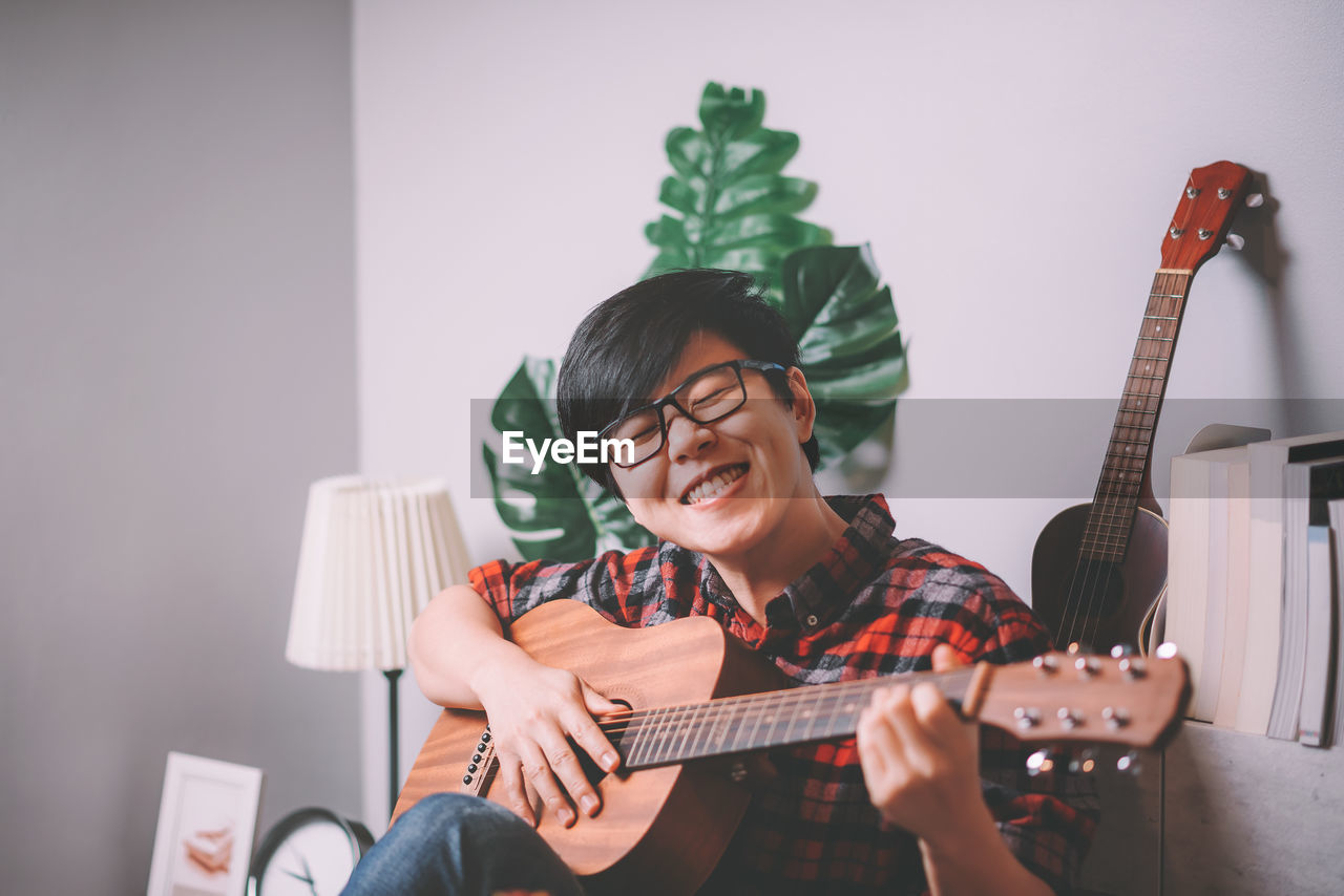 Smiling man playing guitar