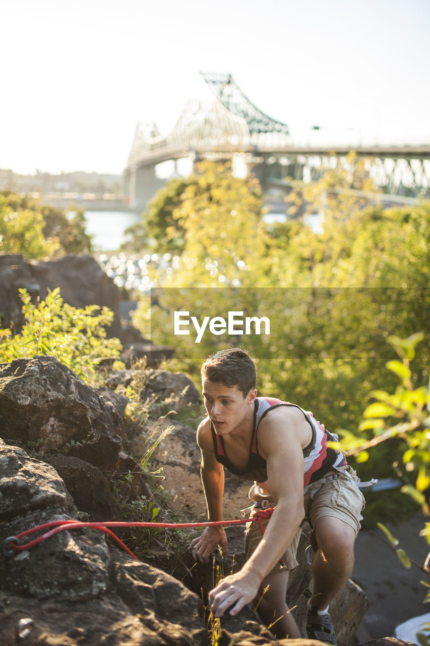 Two friends rock climbing together on summer day