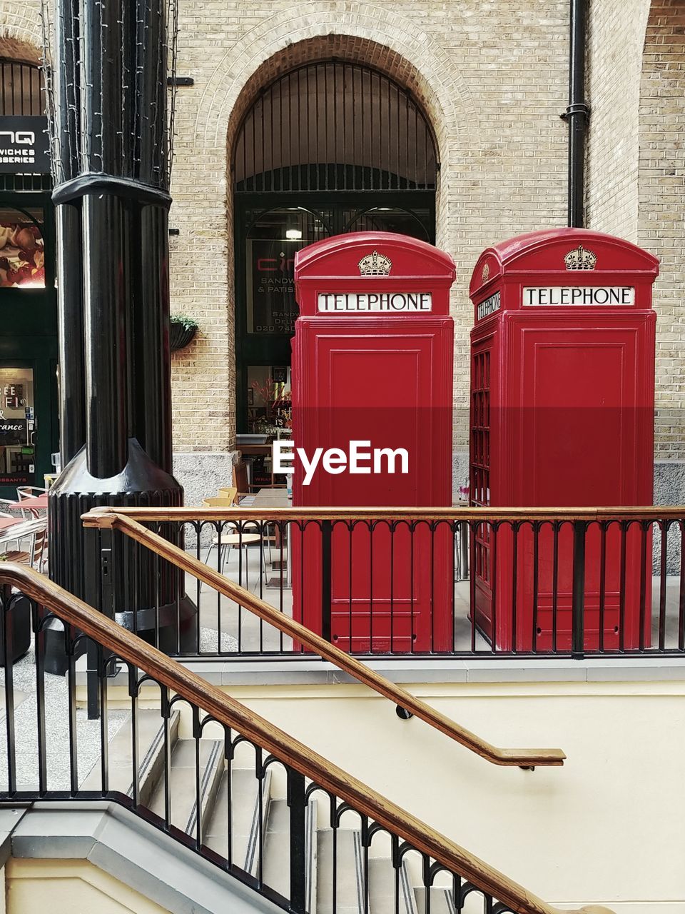 RED TELEPHONE BOOTH ON BUILDING