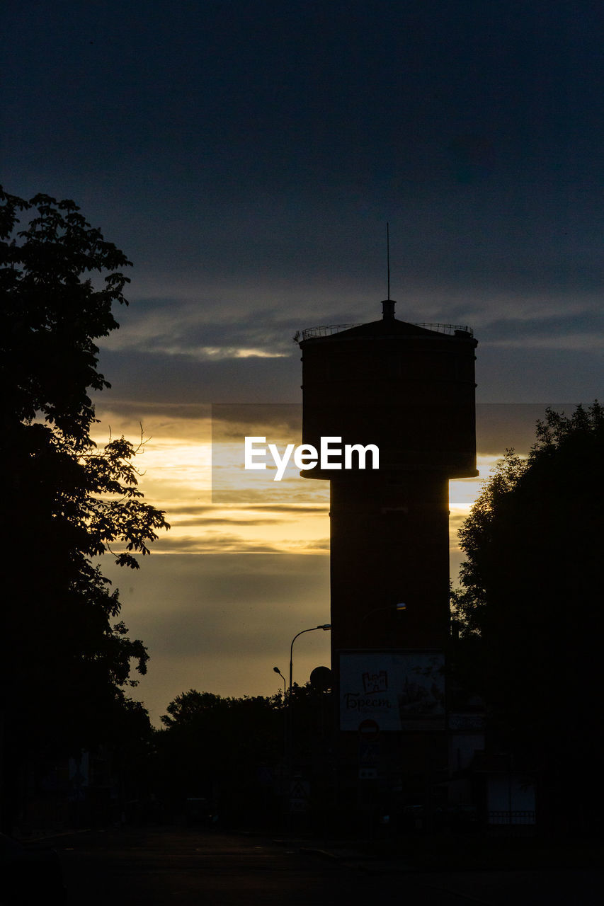 architecture, sky, built structure, silhouette, sunset, darkness, building exterior, night, tower, light, dusk, evening, cloud, building, nature, no people, tree, lighthouse, plant, outdoors, reflection