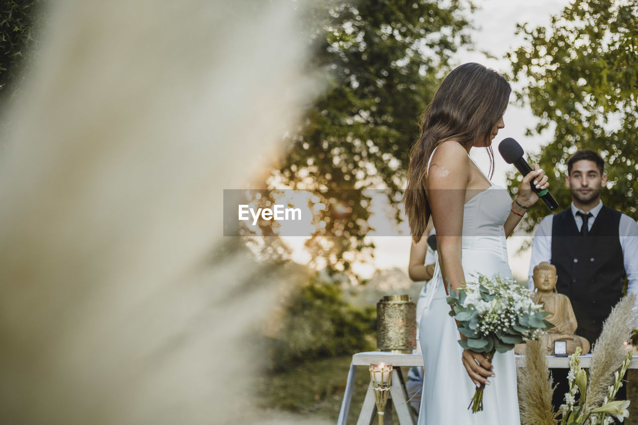 Low angle view of bride talking on wedding ceremony