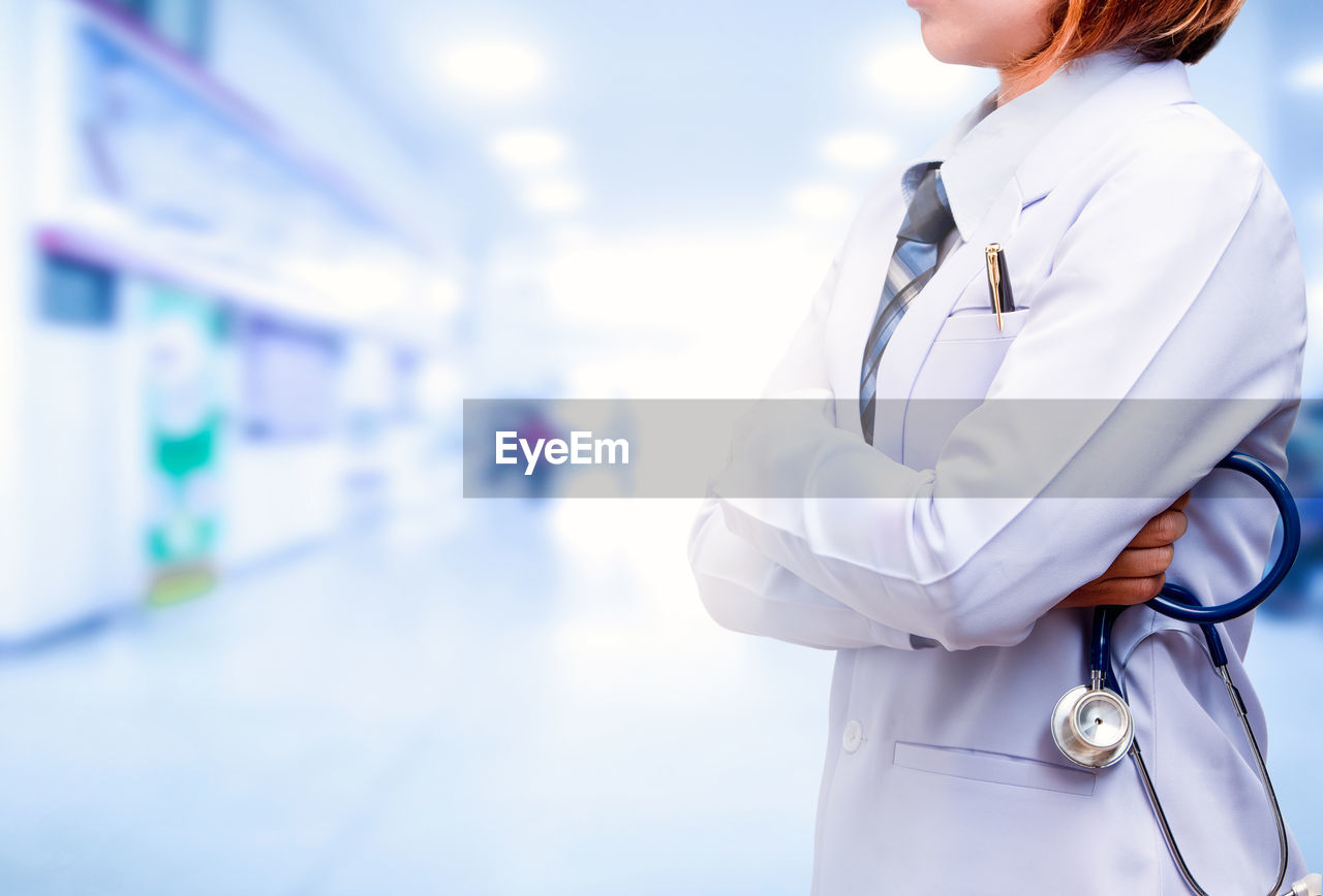 Midsection of female doctor standing in hospital