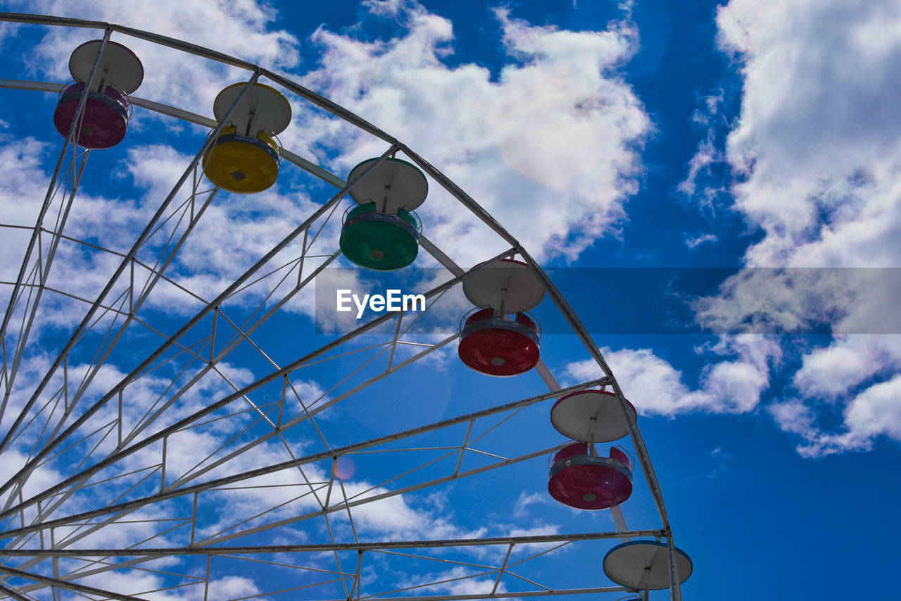 Low angle view of ferris wheel against sky