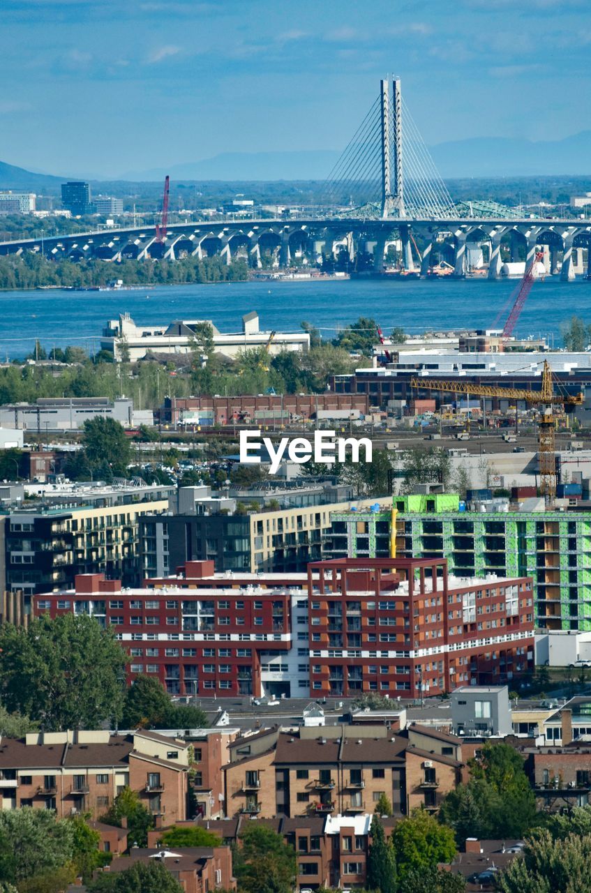 BUILDINGS AGAINST CLOUDY SKY