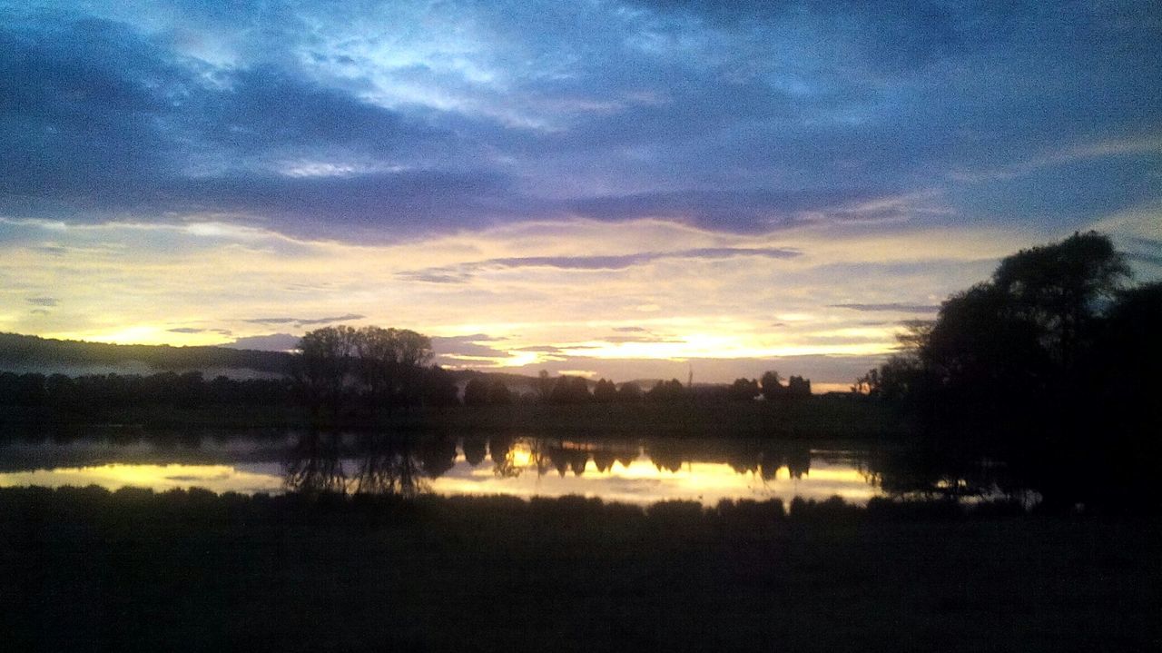 SCENIC VIEW OF LAKE AT SUNSET