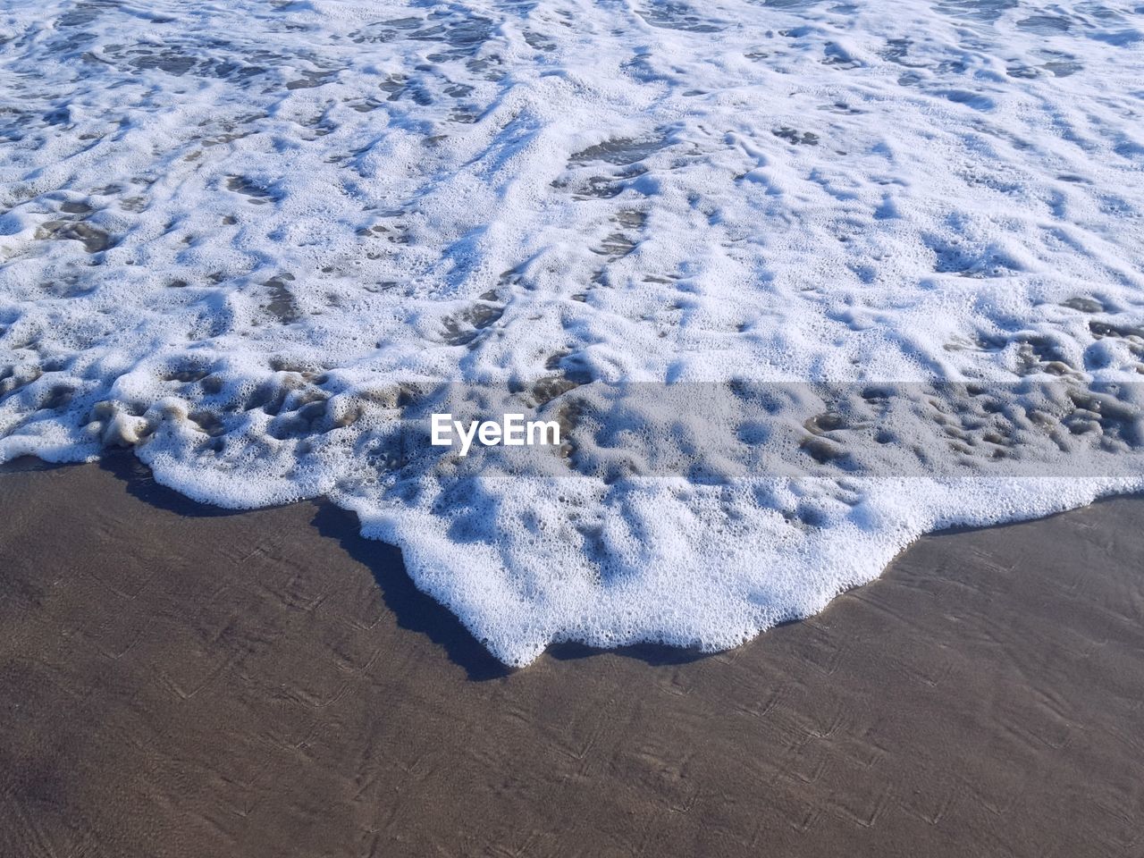 High angle view of waves on beach