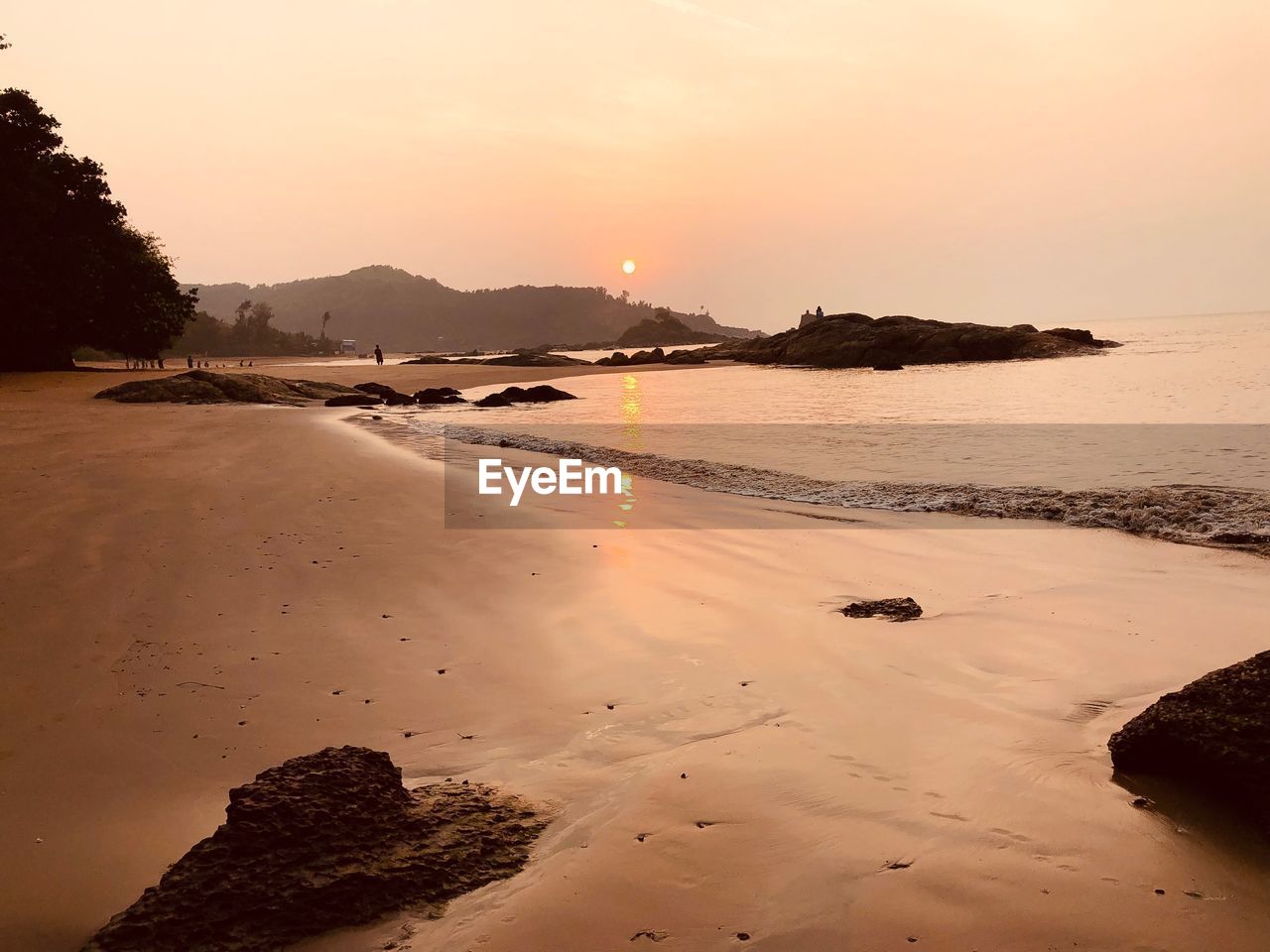 SCENIC VIEW OF BEACH DURING SUNSET