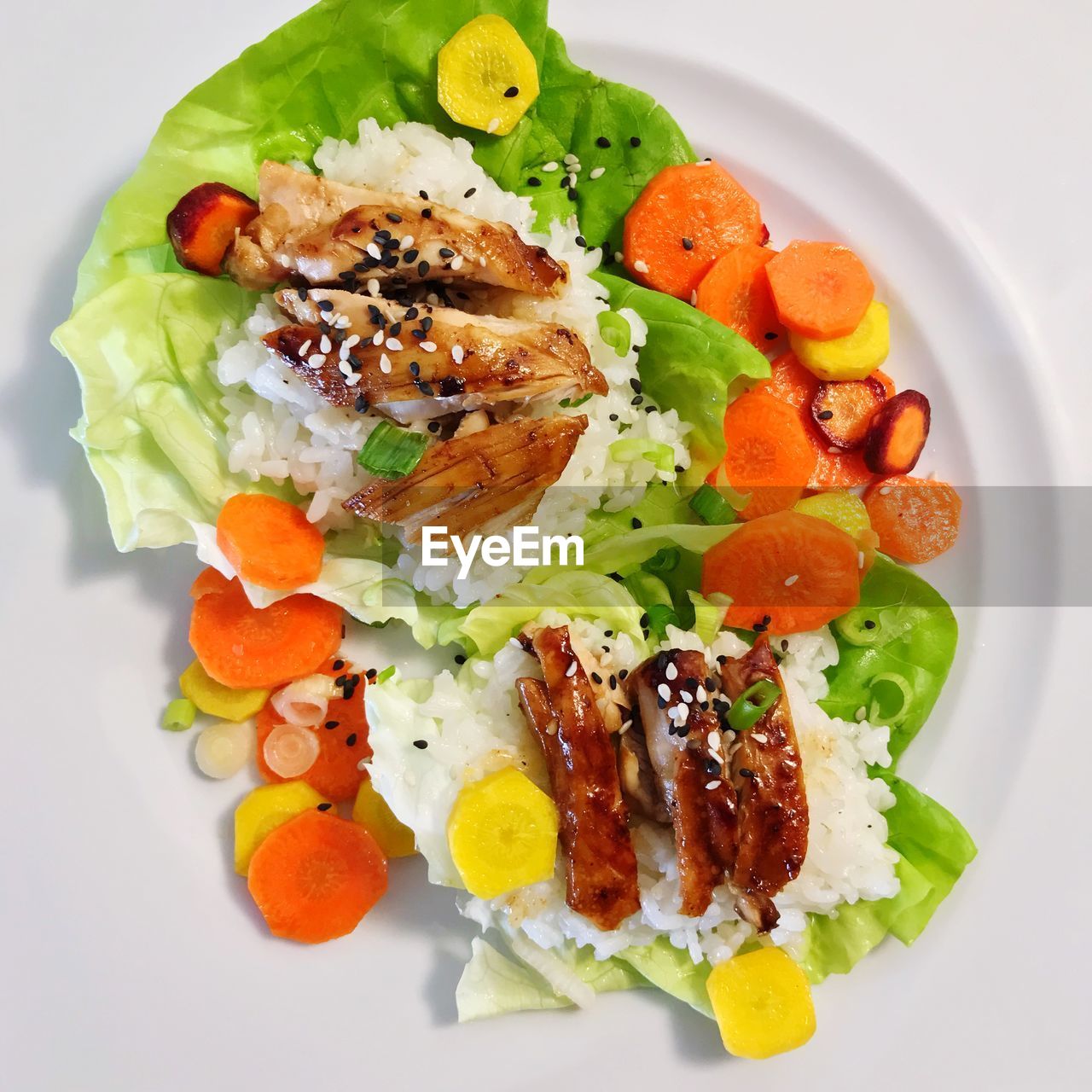 High angle view of salad served in plate of glazed korean chicken lettuce cups