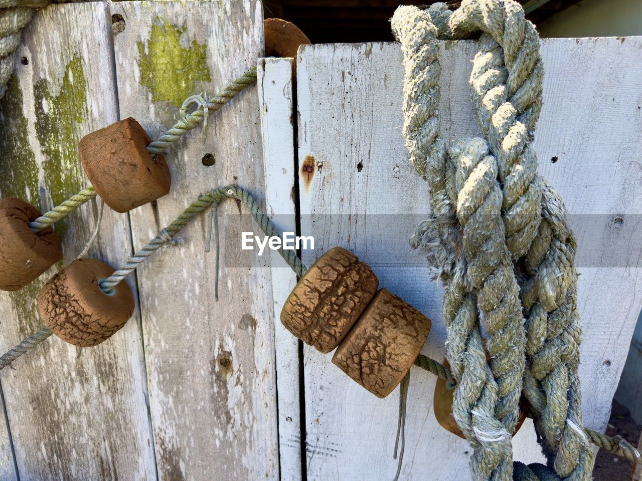 wood, no people, hanging, day, rope, art, outdoors, close-up, protection, nature, metal