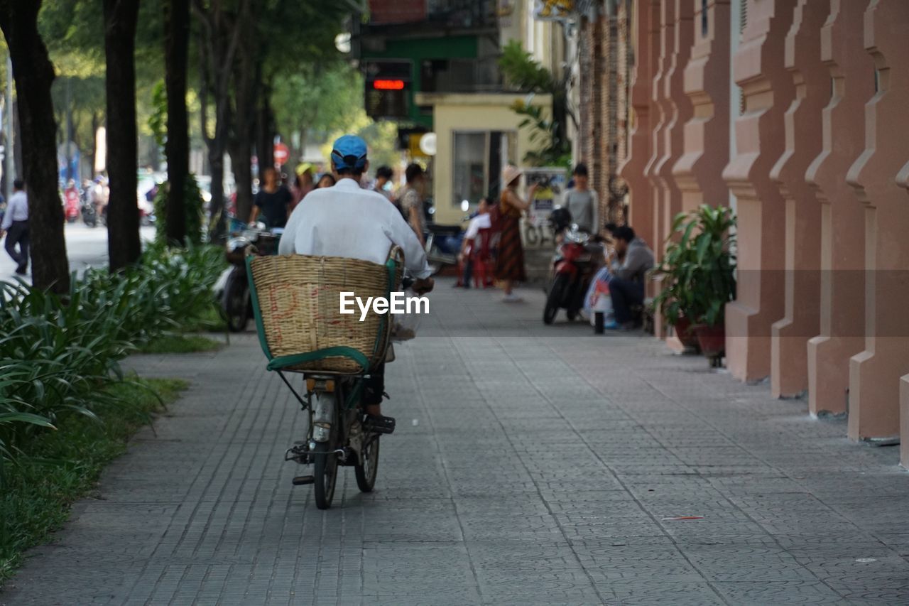 PEOPLE WALKING ON FOOTPATH IN CITY