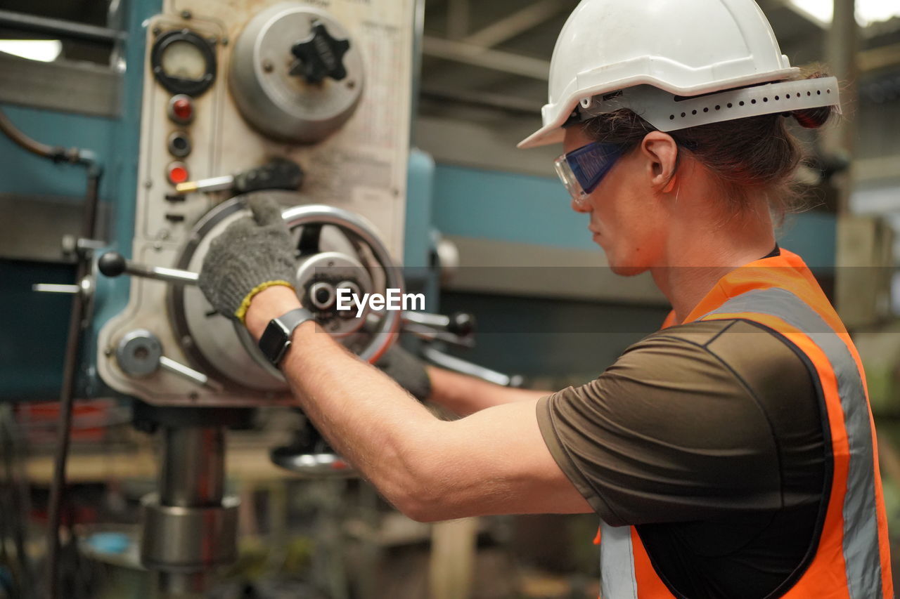 Portrait of male worker standing in the heavy industry manufacturing factory.