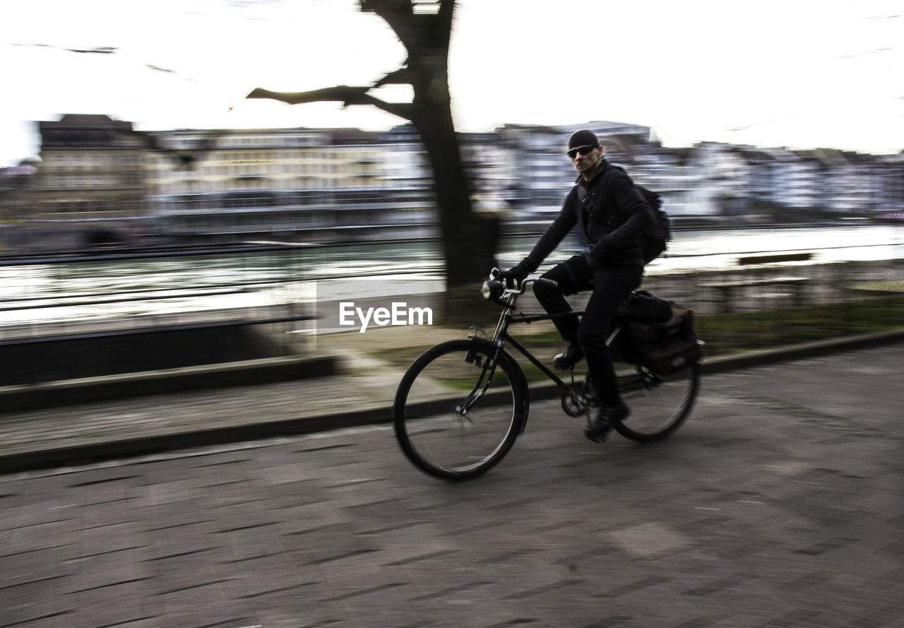 PEOPLE RIDING BICYCLE ON ROAD