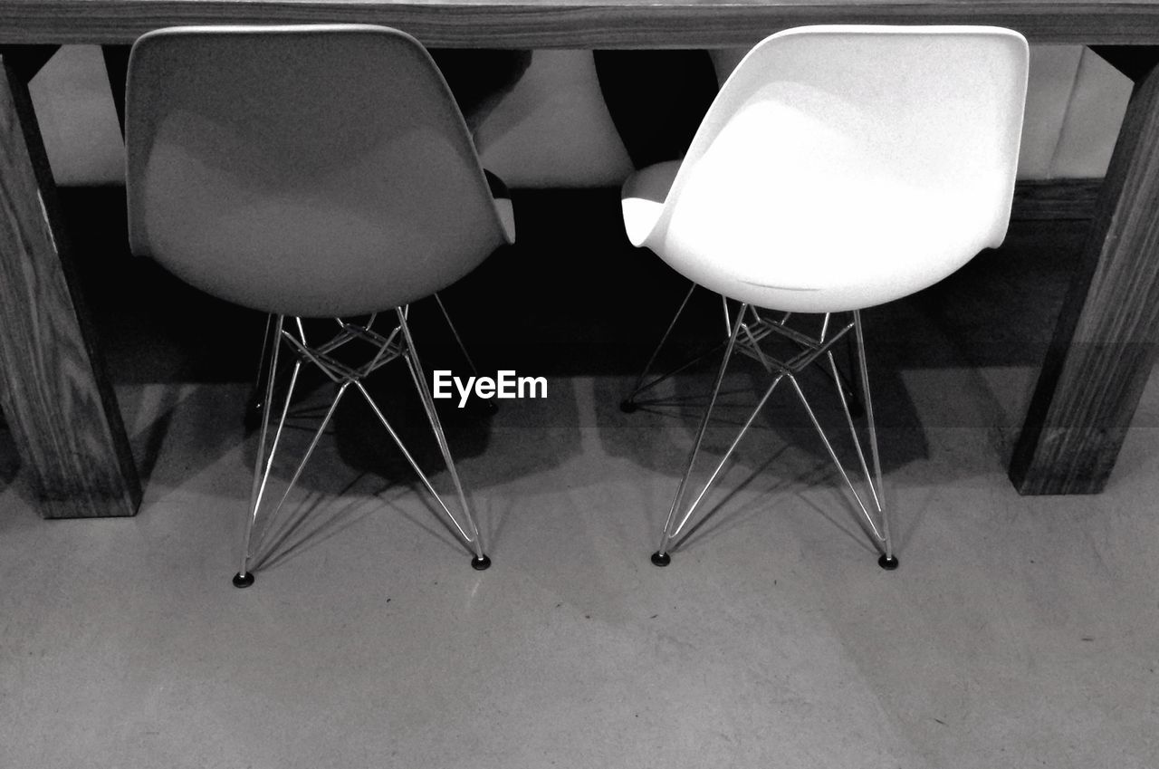 High angle view of chairs by table on floor