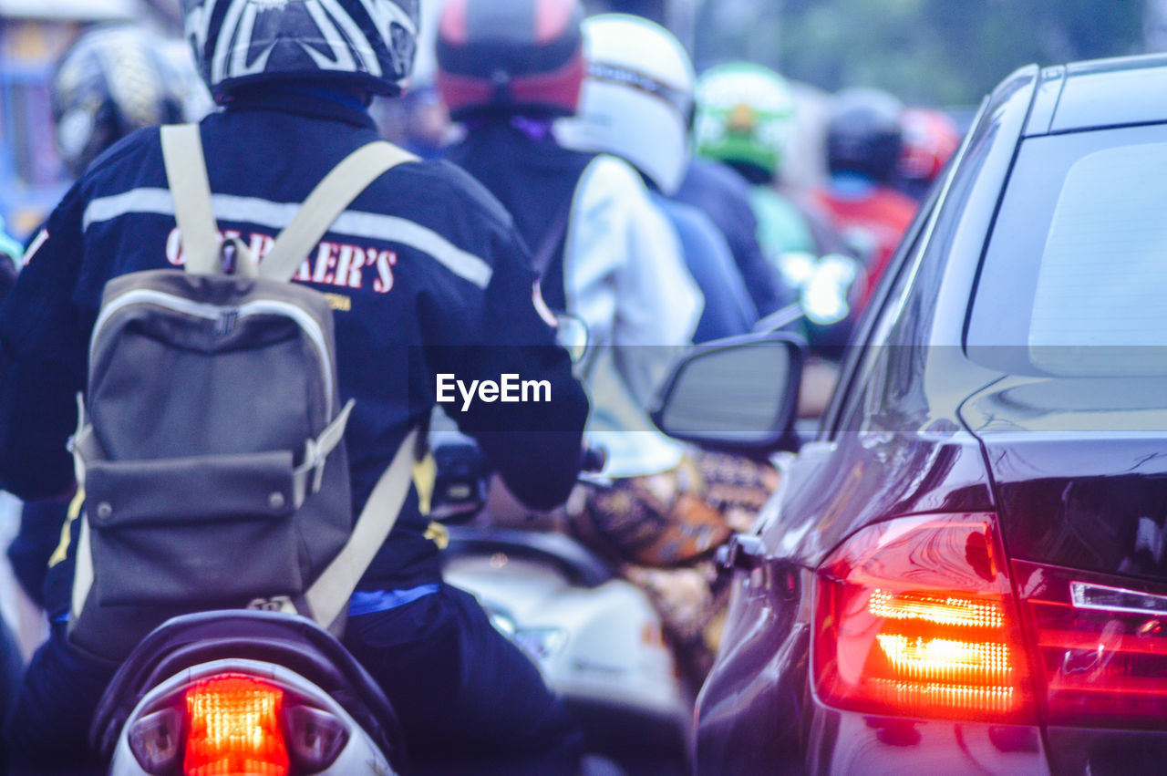 People on motorcycle during traffic