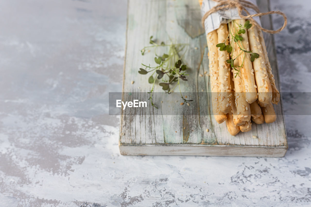 Italian grissini or salted breadsticks. fresh italian snack with sesame seeds.