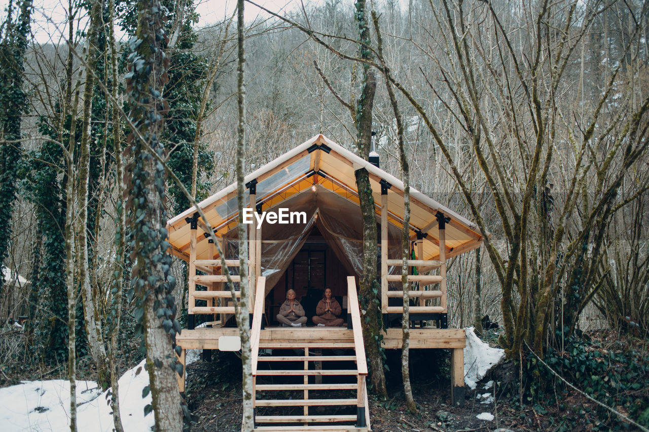 Women doing meditation in cabin