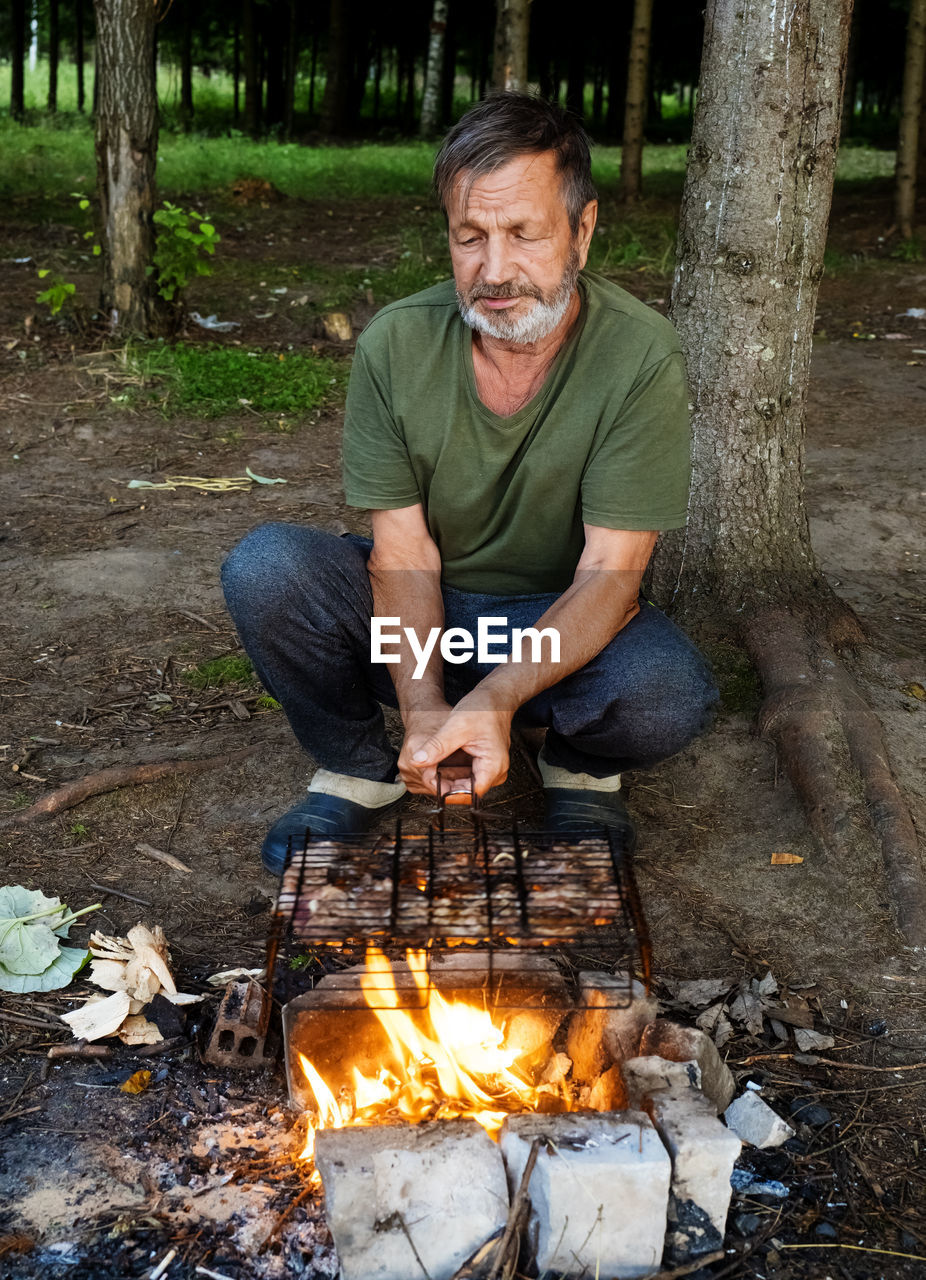 Man preparing food on barbecue grill