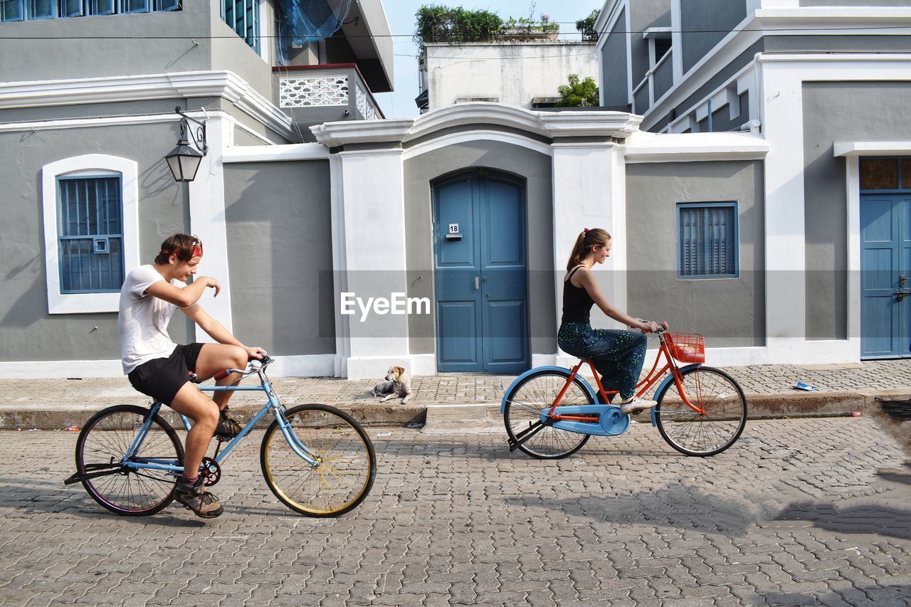 MAN RIDING BICYCLE ON BUILDING