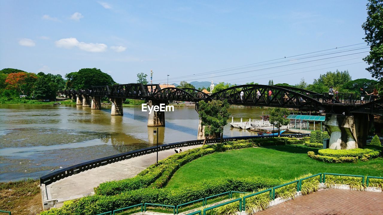 ARCH BRIDGE IN GARDEN AGAINST SKY