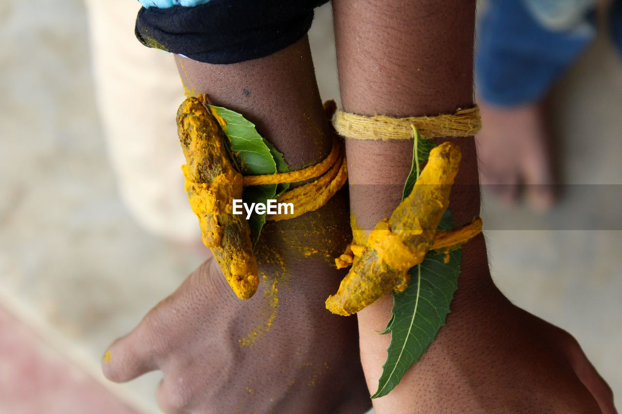 Turmeric root and neem leaf will tie on temple festival .