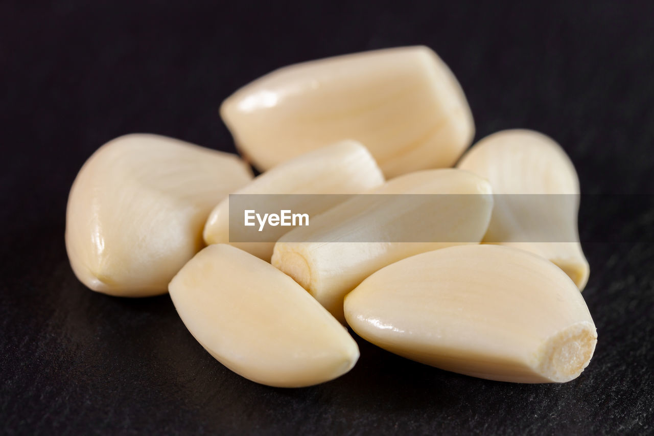 food, healthcare and medicine, food and drink, medicine, pill, wellbeing, dose, indoors, vitamin, studio shot, healthy eating, nutritional supplement, freshness, close-up, black background, no people, still life, capsule, garlic, alternative medicine, antioxidant, herb, ingredient, produce