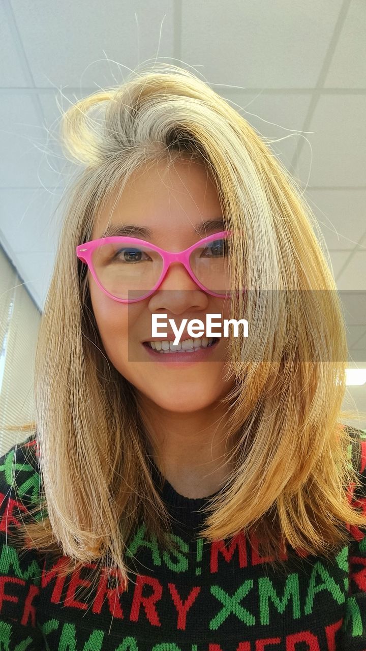 portrait, human hair, one person, blond hair, smiling, glasses, hairstyle, looking at camera, happiness, women, headshot, front view, long hair, vision care, indoors, emotion, human face, clothing, child, eyeglasses, fashion, lifestyles, brown hair, adult, teeth, cheerful, smile, teenager, young adult, nose, pink, female, human head, person, casual clothing, hair color, close-up, leisure activity, childhood, human eye, fun