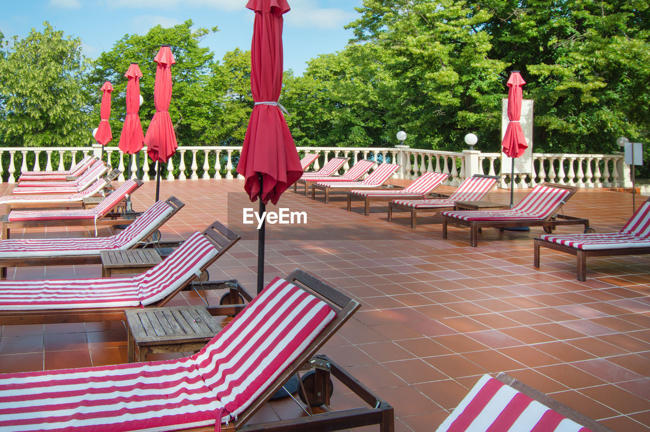 EMPTY CHAIRS AND TABLES IN PARK