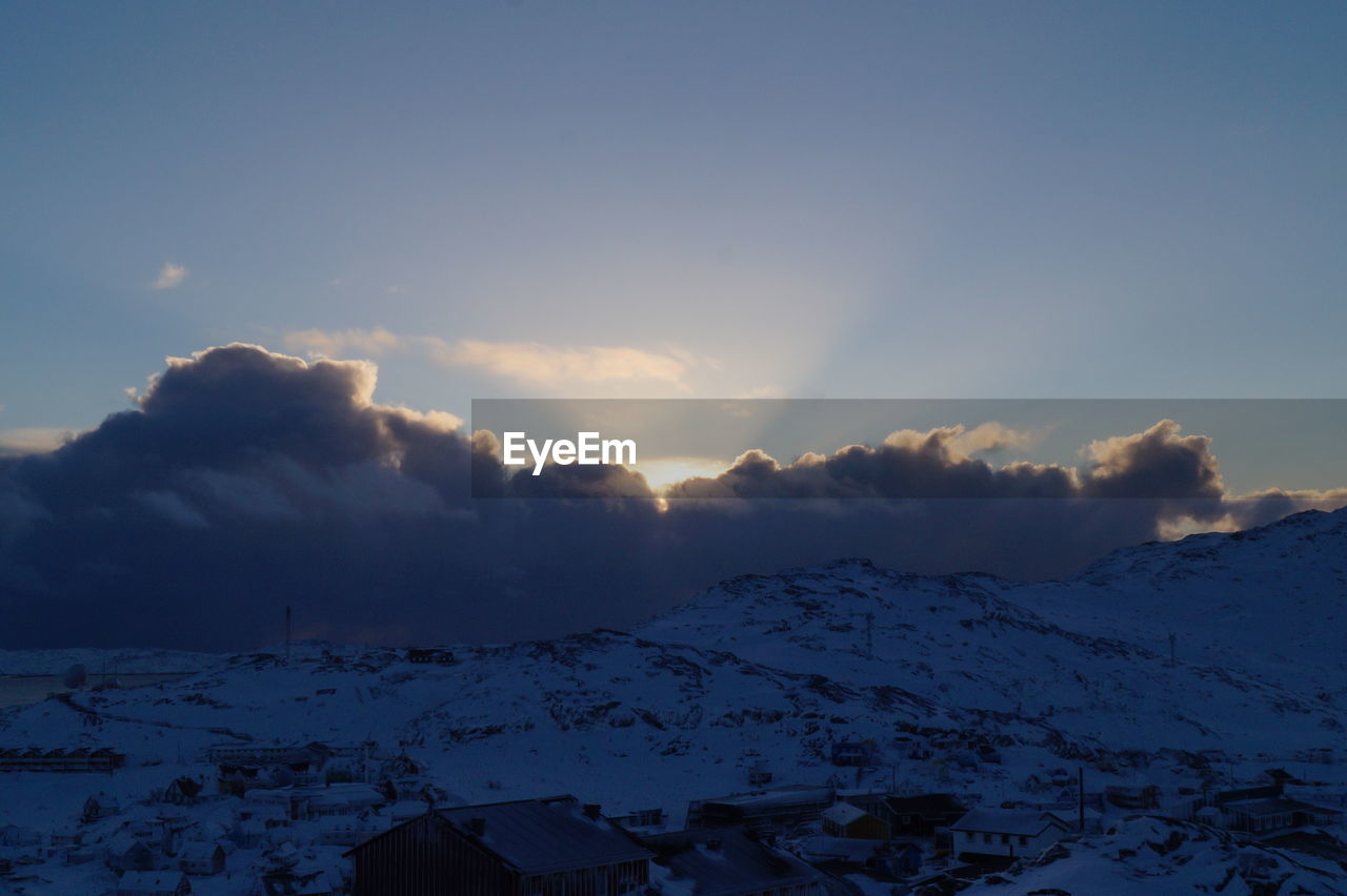 Scenic view of snow covered mountains against sky