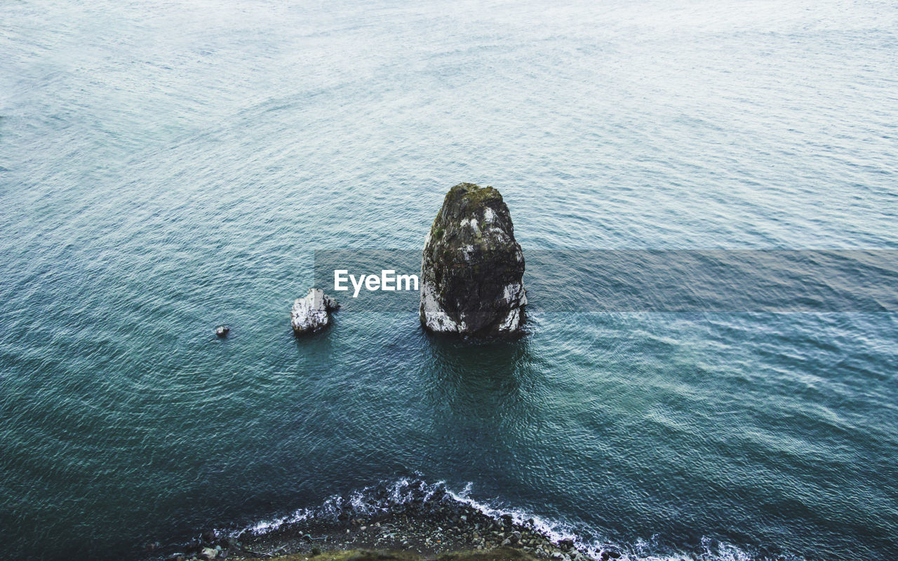 High angle view of rocks in sea