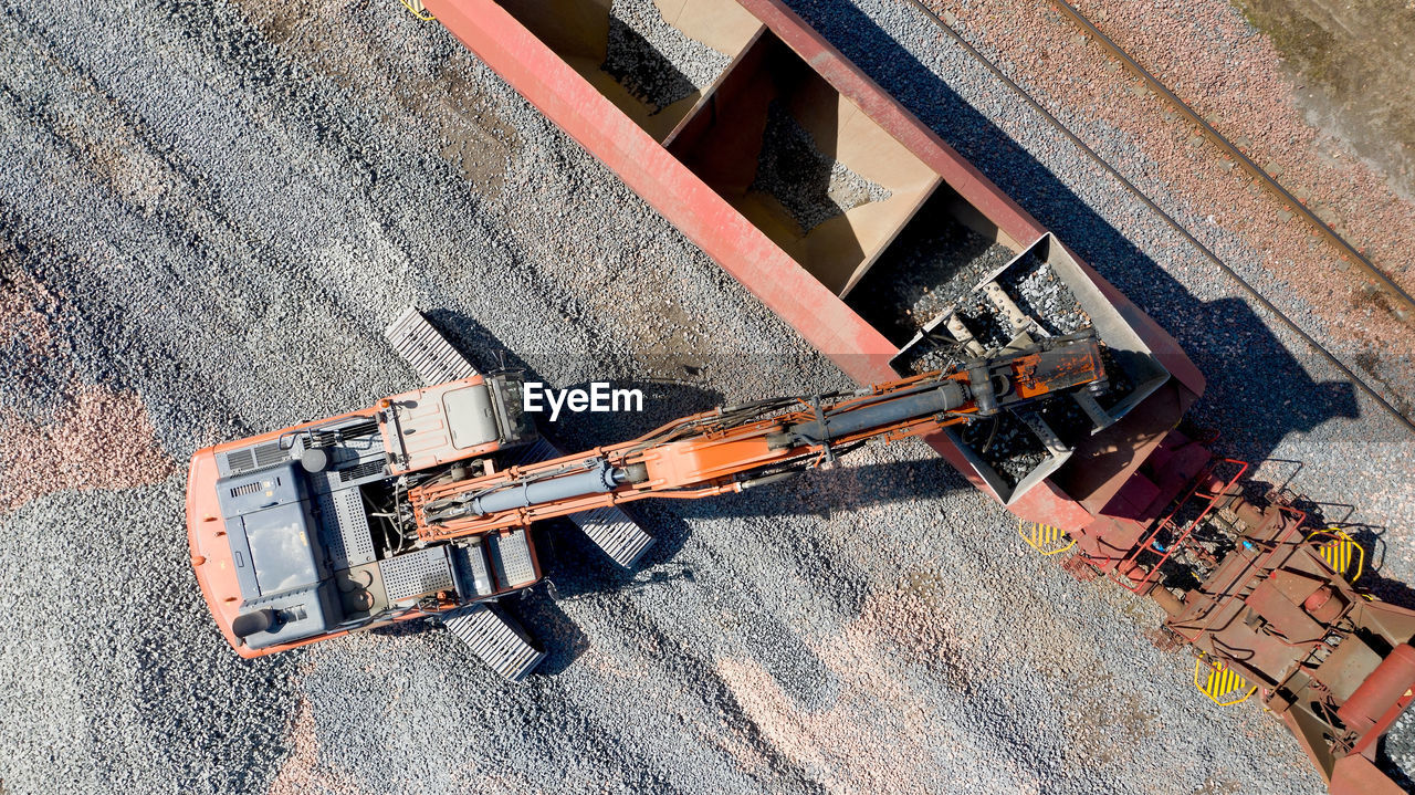 HIGH ANGLE VIEW OF CONSTRUCTION SITE BY ROAD