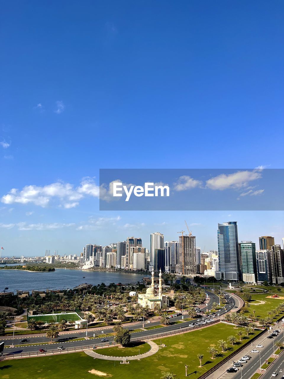 architecture, city, sky, built structure, building exterior, building, cityscape, horizon, office building exterior, skyline, skyscraper, urban skyline, landscape, nature, travel destinations, metropolitan area, cloud, urban area, residential district, blue, residential area, landmark, aerial photography, transportation, water, travel, no people, city life, day, high angle view, tower block, outdoors, road, office, downtown, street, downtown district, tourism, mode of transportation