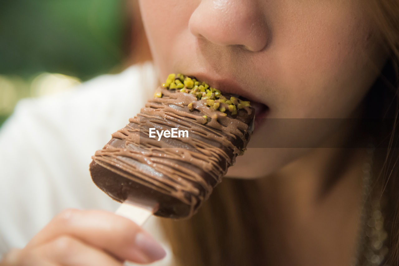 Close-up of woman eating chocolate ice cream