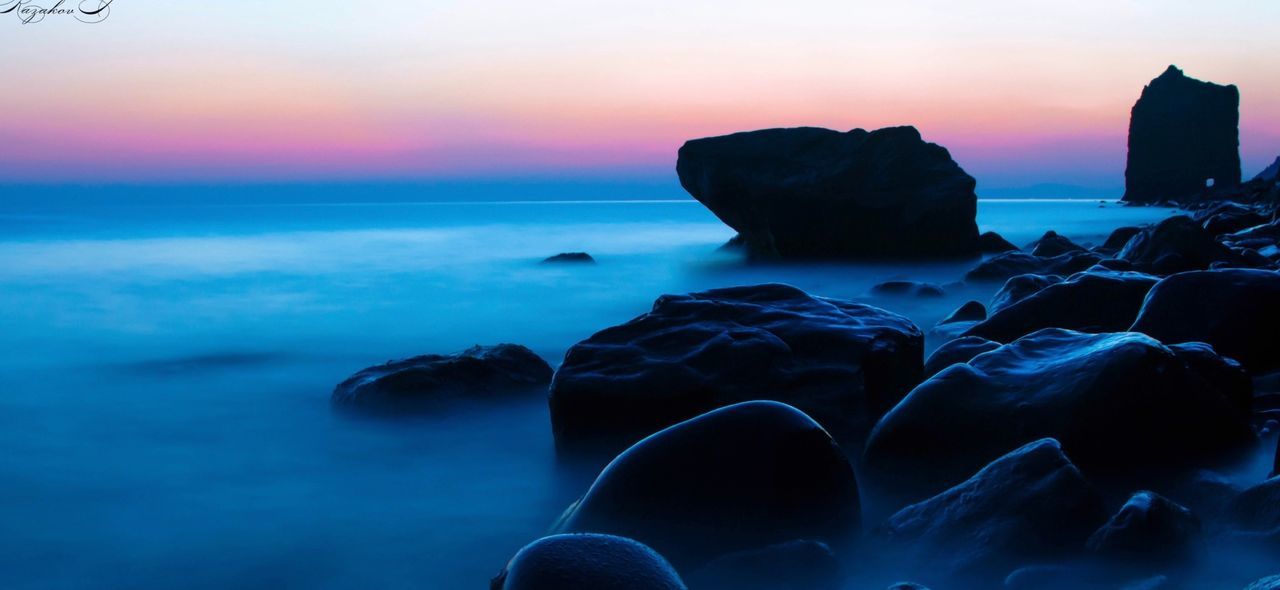 Scenic view of calm sea at sunset