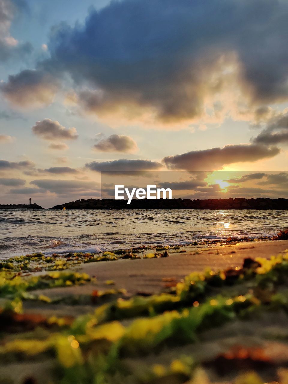 Scenic view of beach against sky during sunset