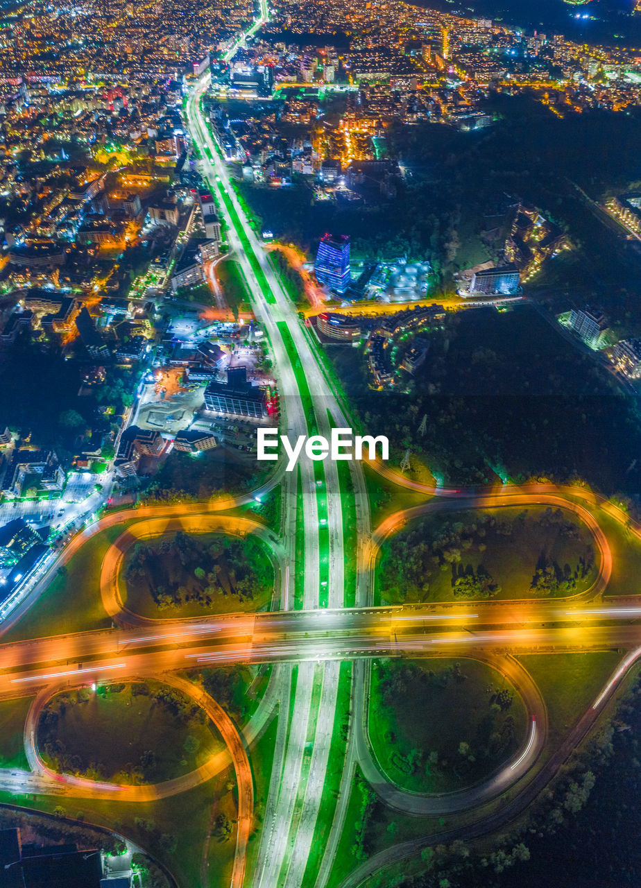 DIGITAL COMPOSITE IMAGE OF ILLUMINATED CITYSCAPE AND BRIDGE IN CITY