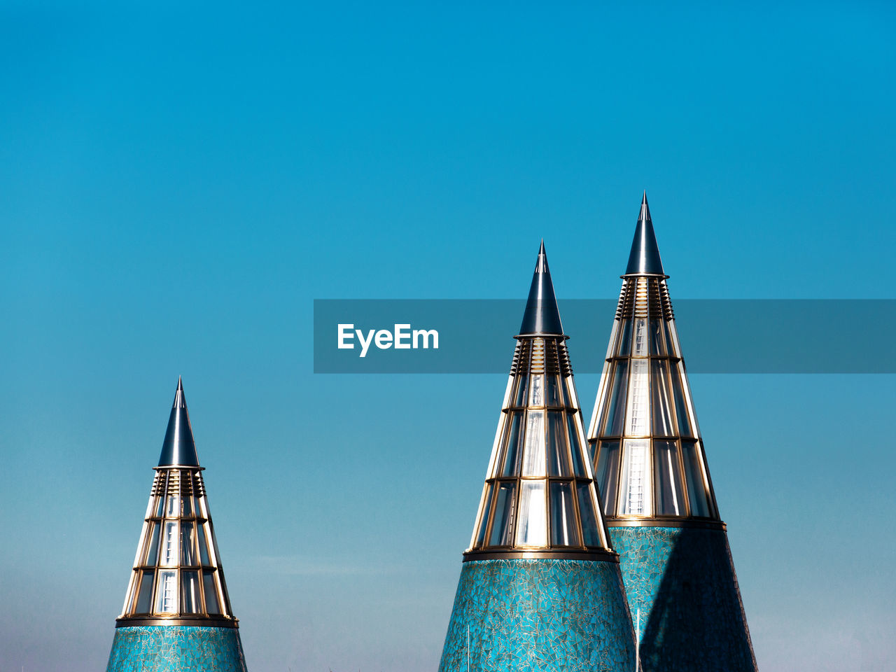 Low angle view of modern buildings against blue sky