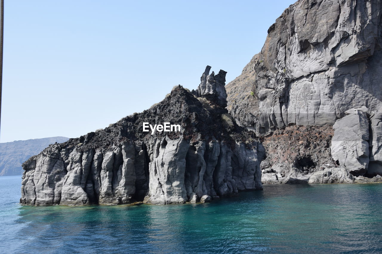 ROCK FORMATIONS BY SEA AGAINST SKY