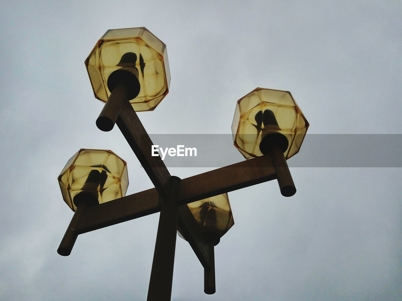 Low angle view of antique street light against sky