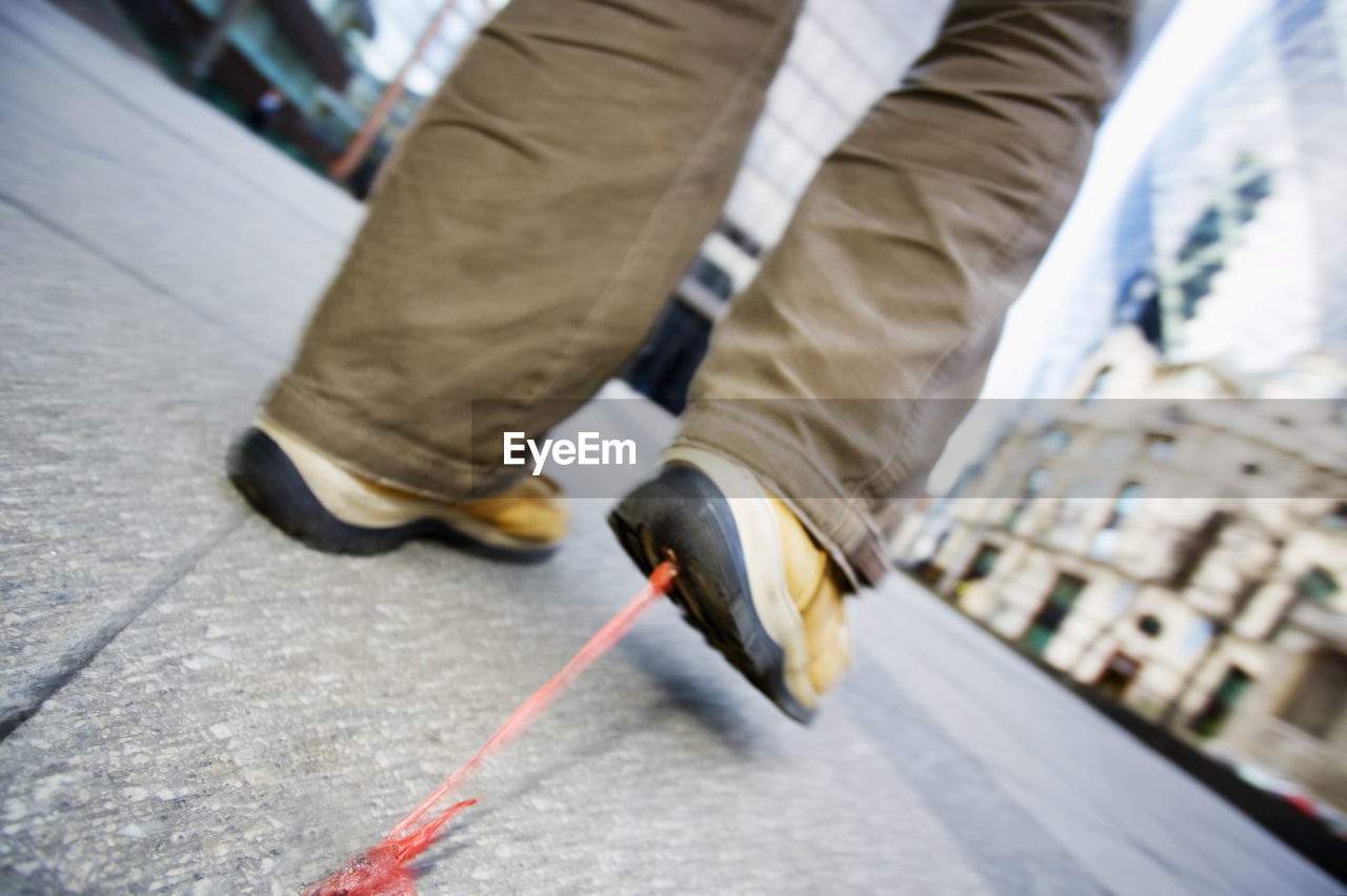 LOW SECTION OF MAN WALKING ON STREET