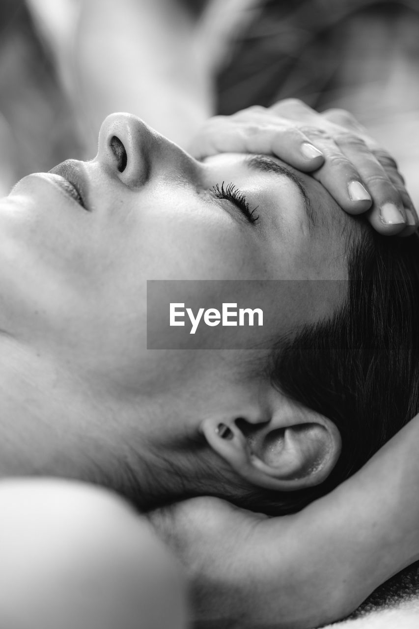 Cranial osteopathy massage. therapist massaging womans head.