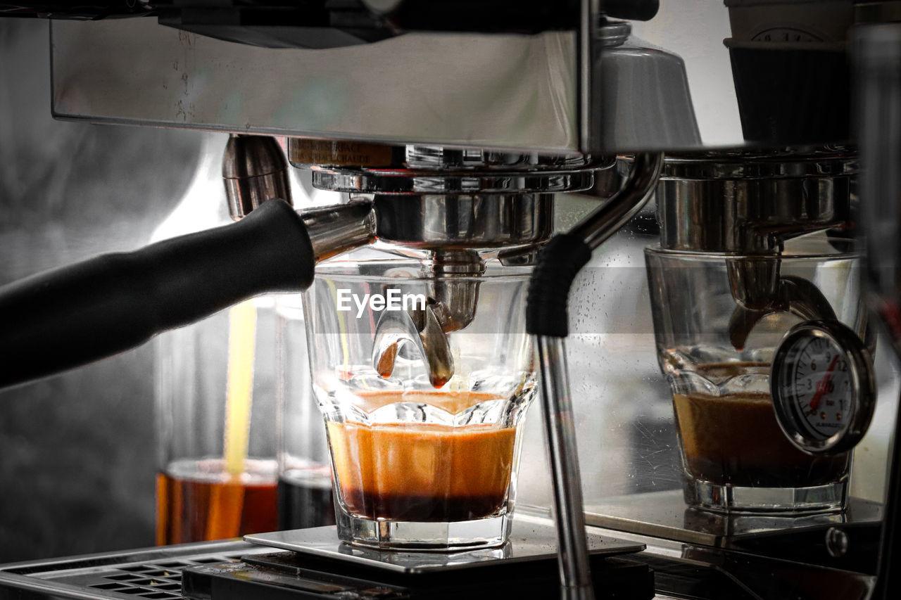 CLOSE-UP OF COFFEE CUPS IN GLASS