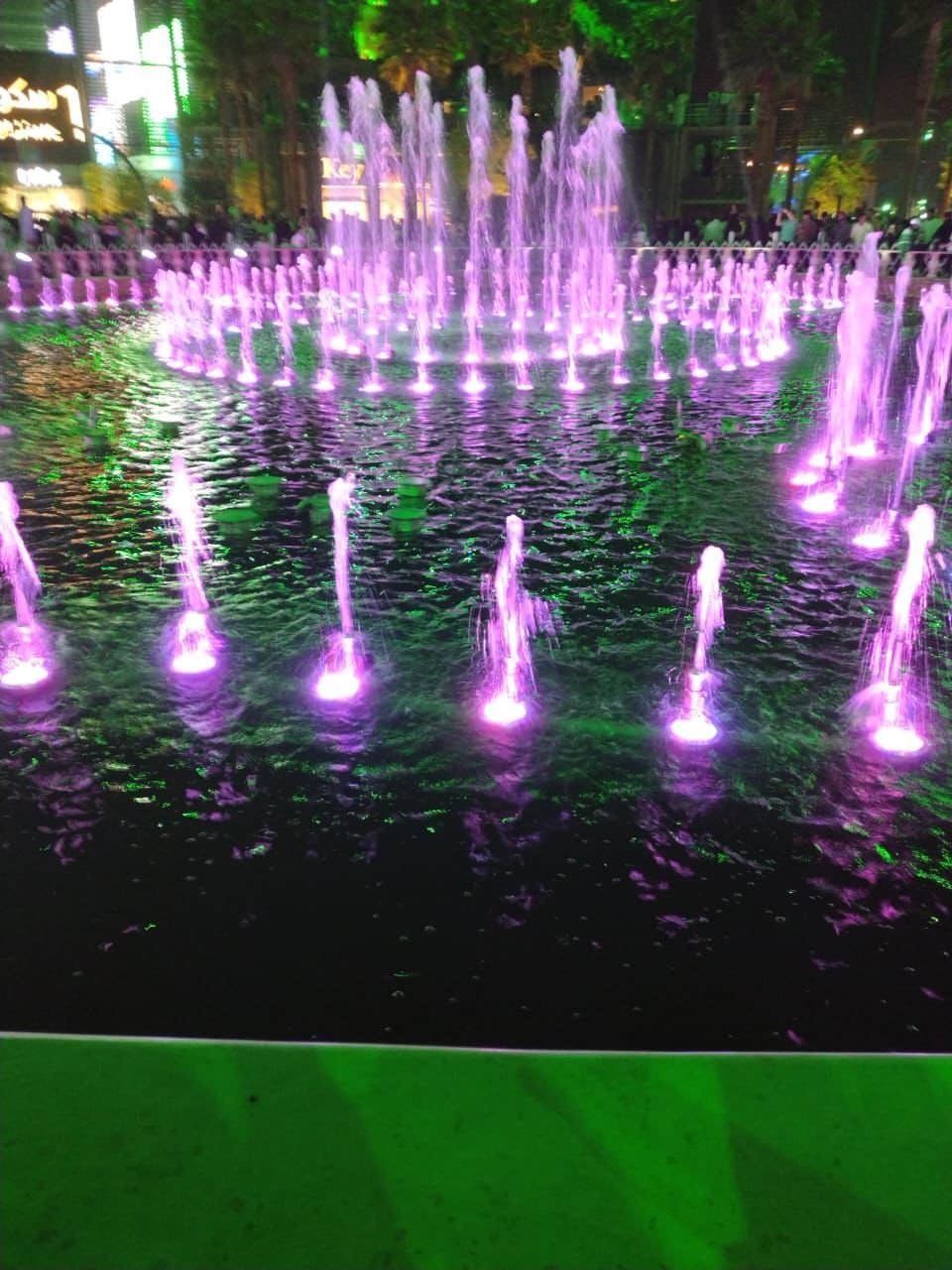 water, fountain, water feature, illuminated, motion, nature, no people, night, plant, outdoors, light, reflection, green, tree, architecture, long exposure