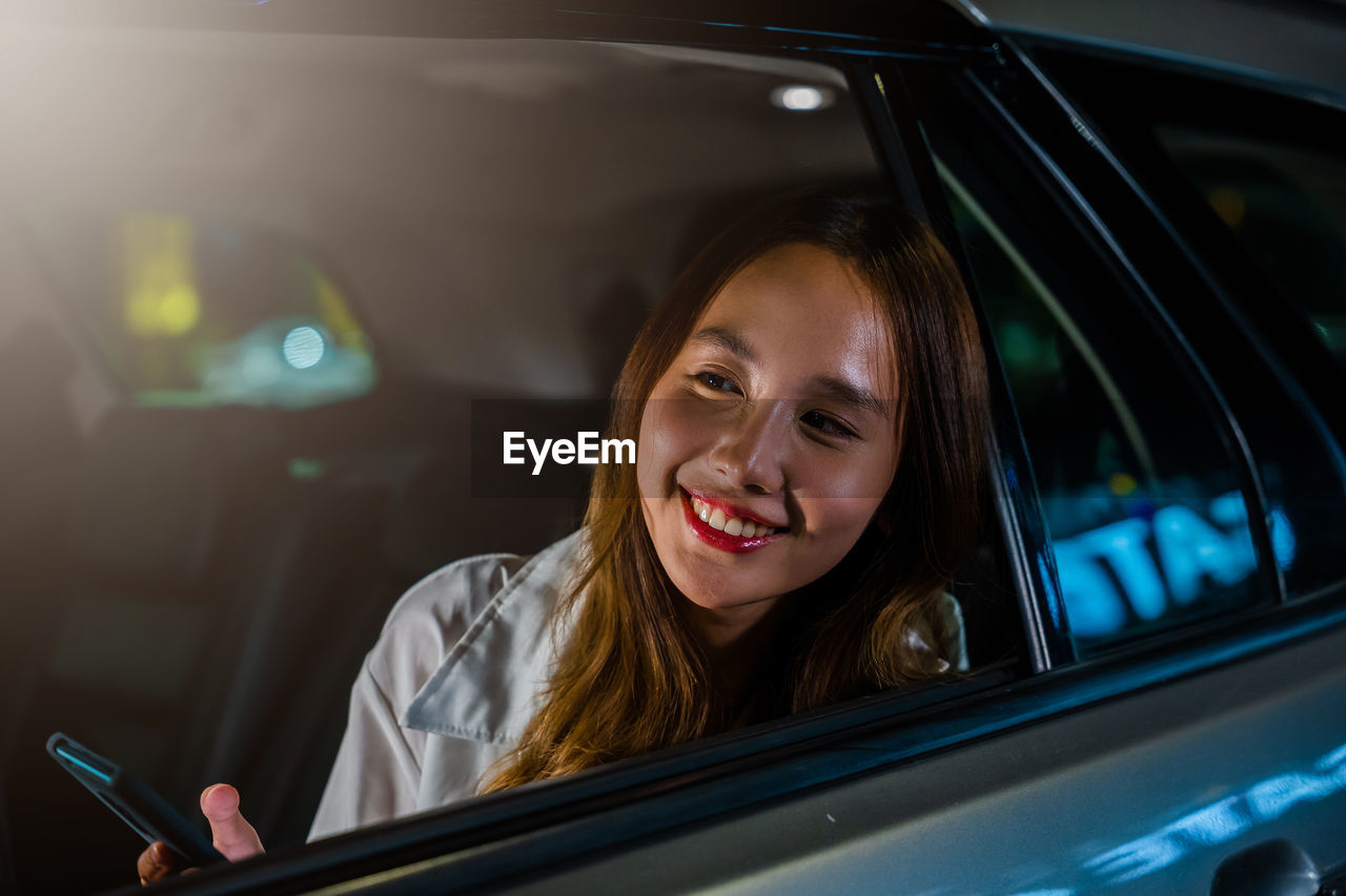 portrait of woman sitting in car