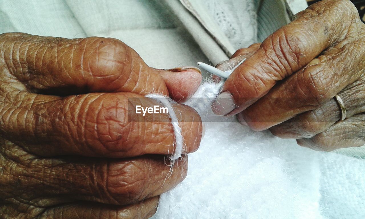 CLOSE-UP OF HUMAN HAND IN THE DARK