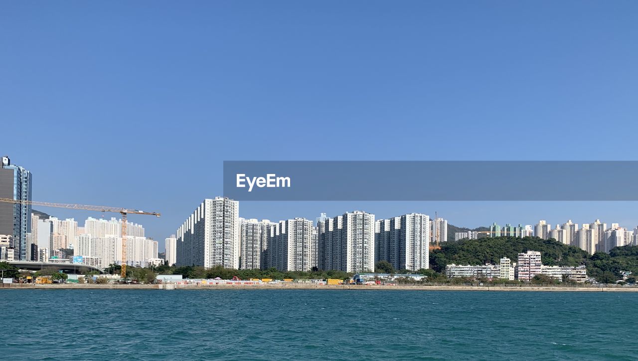 SEA BY BUILDINGS AGAINST CLEAR SKY