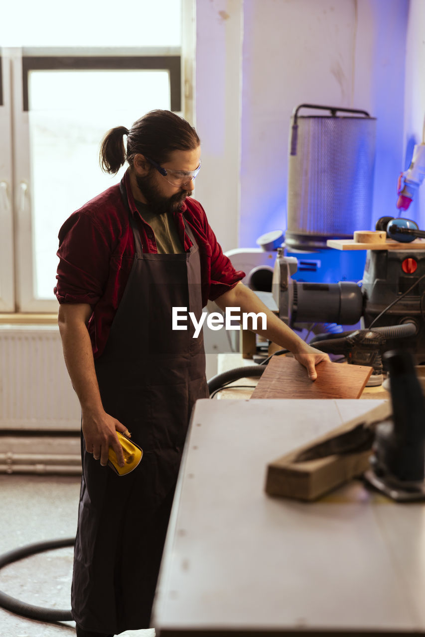 side view of man working in workshop