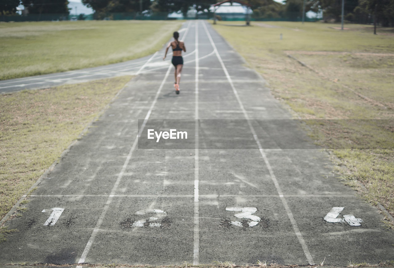 Woman running on track